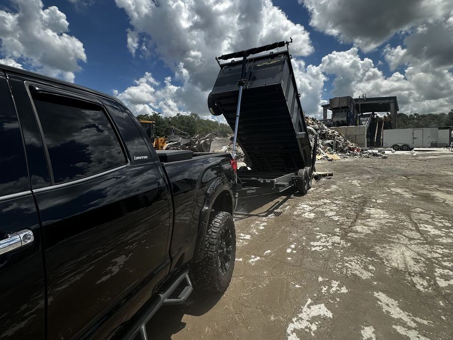 Apex Removal Solutions dump trailer unloading at a disposal facility